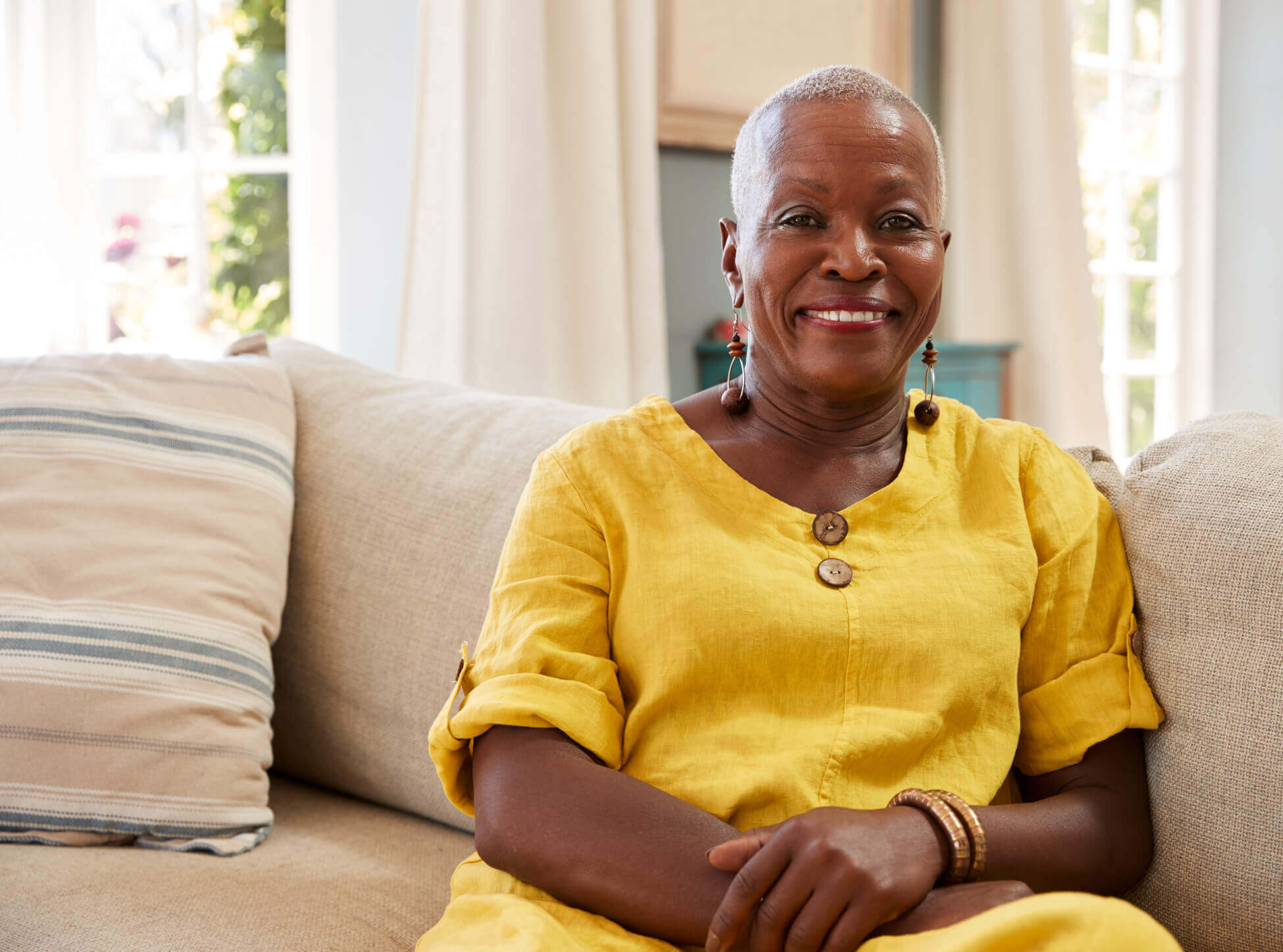 Smiling mature woman on couch