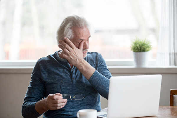 older man at computer with dry eye