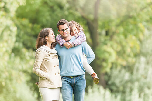 Young family outside walking