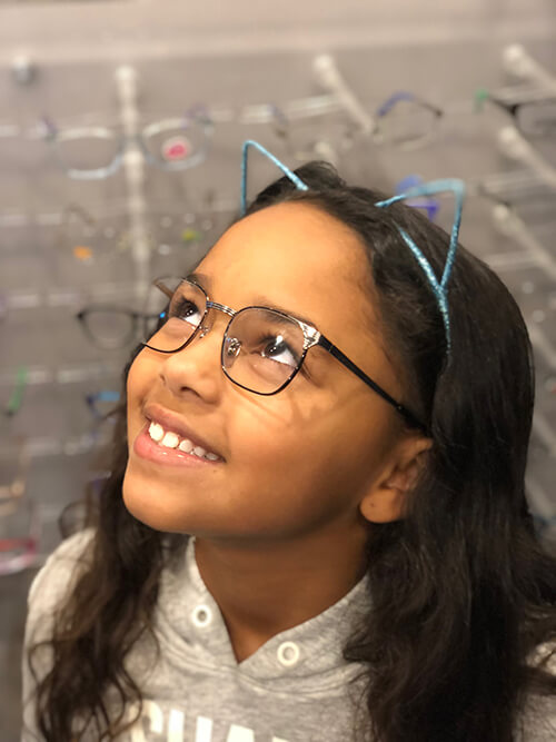 Young girl in glasses with cat ear headband